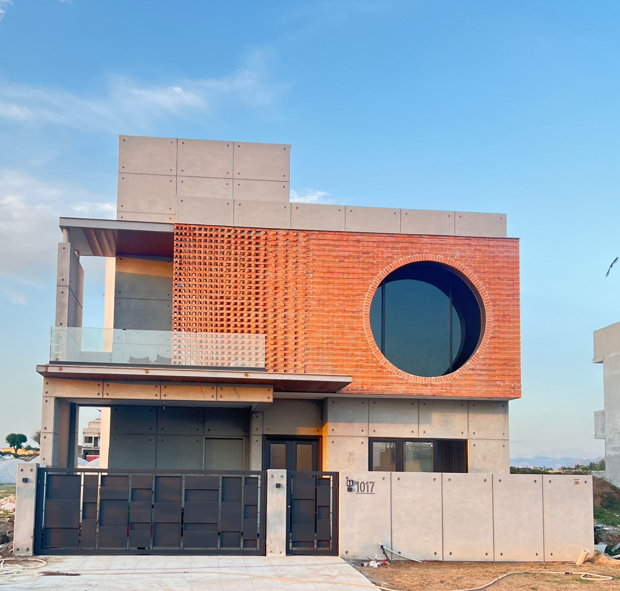 Modern concrete and brick residence by Imran Builders